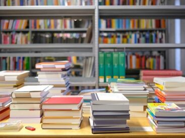 Shelving and a table of books