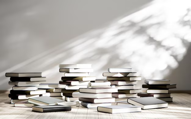 Stack of books next to a white wall