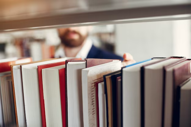 A man takes a book from a shelf