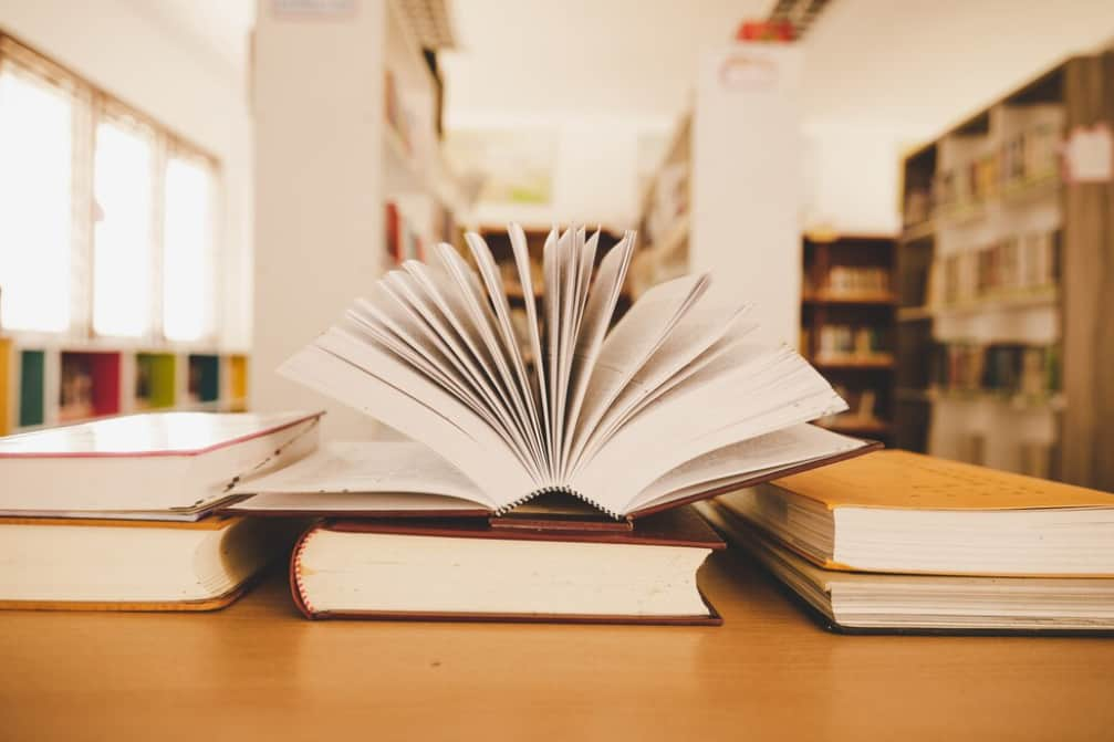 Open book on a desk with flipping pages in a library setting