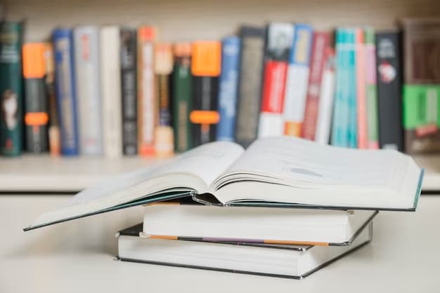 3 books lying on the table, one open