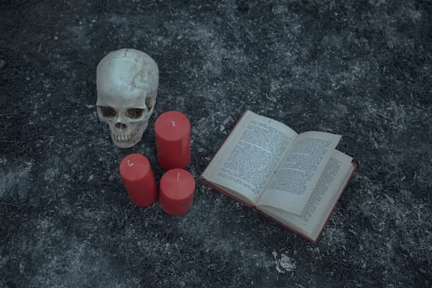 An open book lies near 3 candles and a skull