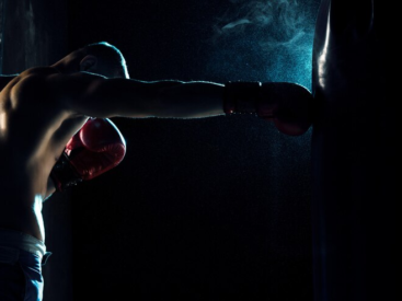 Man Boxing in Punching Bag