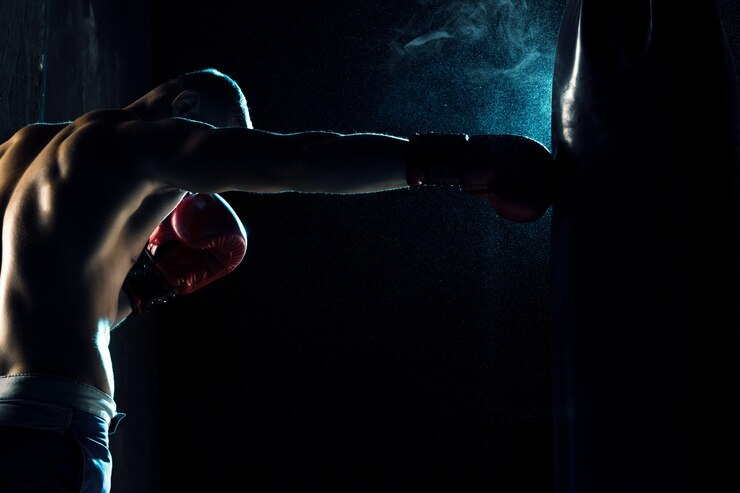 Man Boxing in Punching Bag